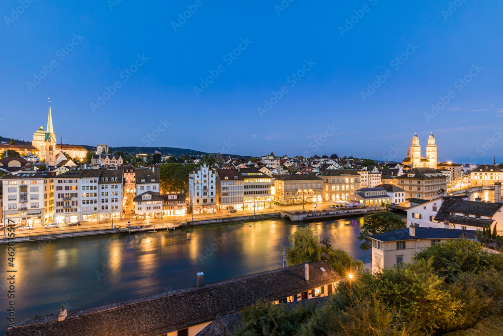 Switzerland, Canton of Zurich, Zurich, RiverÔøΩLimmatÔøΩand old town buildings alongÔøΩilluminatedÔøΩLimmatquaiÔøΩstreet at dusk Switzerland, Canton of Zurich, Zurich, RiverÔøΩLimmatÔøΩand old town buildings alongÔøΩilluminatedÔøΩLimmatquaiÔøΩstreet at dusk