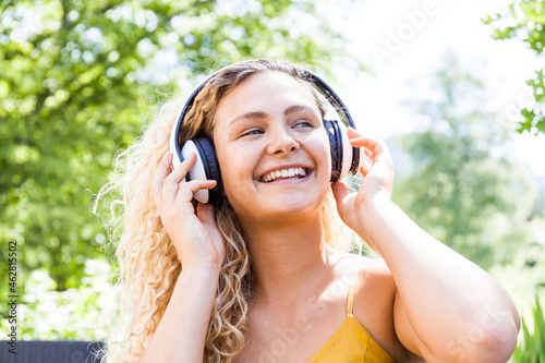 Smiling woman listening to music outdoor