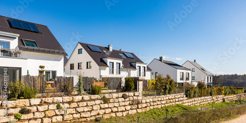 Houses with solar panels on roof against clear blue sky, Baden-WÔøΩrttemberg, Germany photo