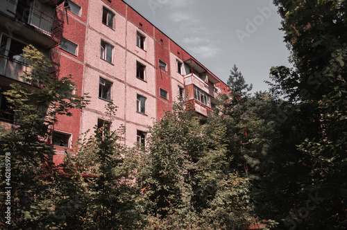 A radioactive abandoned building overgrown with trees in the city of Pripyat