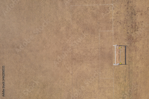 Aerial view of goal post on dry soccer field in summer during drought photo