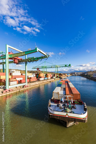 Germany, Baden-Wurttemberg, Stuttgart, Container ship at commercial dock on bank ofÔøΩNeckarÔøΩriver