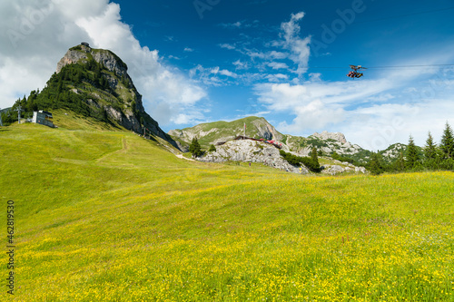 Austria, Tyrol, Maurach, Rofan Mountains, cable car, Airrofan Skyglider over flower meadow photo