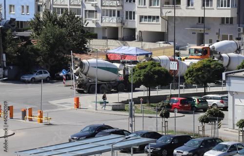 Heavy concrete trucks are waiting near a construction site in the city, trucks are making heavy air pollution