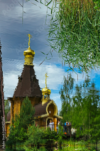 Russia, Leningrad Oblast, Church of Saint Andrew at Vuoksa reflecting in clear water of Vuoksi river photo