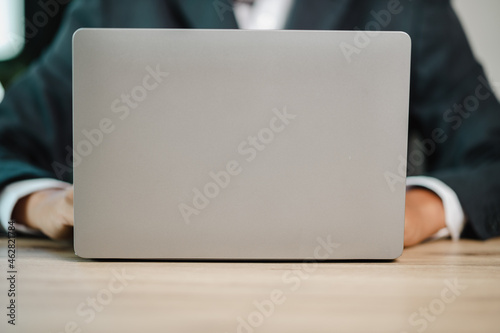 A middle-aged Asian businessman Stressed sitting at his working place in offie In front of his is laptop. photo