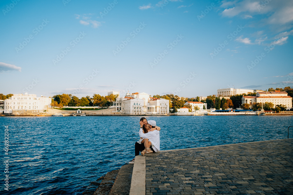 a man and a woman in love at sunset, on the sea embankment a man and a woman in love at sunset, on the sea embankment