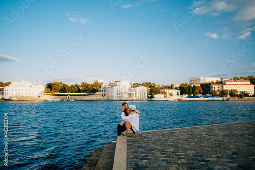 a man and a woman in love at sunset, on the sea embankment © Александр Хромов