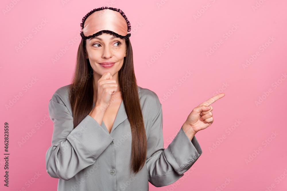 Photo of mature woman happy positive smile look point finger empty space ad select decision isolated over pink color background Photo of mature woman happy positive smile look point finger empty space ad select decision isolated over pink color background