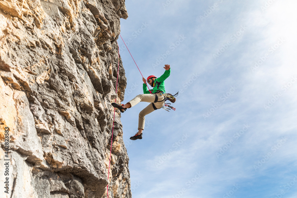 Italy, Cortina d'Ampezzo, man abseiling in the Dolomites mountains Italy, Cortina d'Ampezzo, man abseiling in the Dolomites mountains