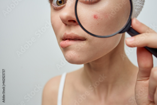 woman with a magnifying glass in hand hygiene treatment