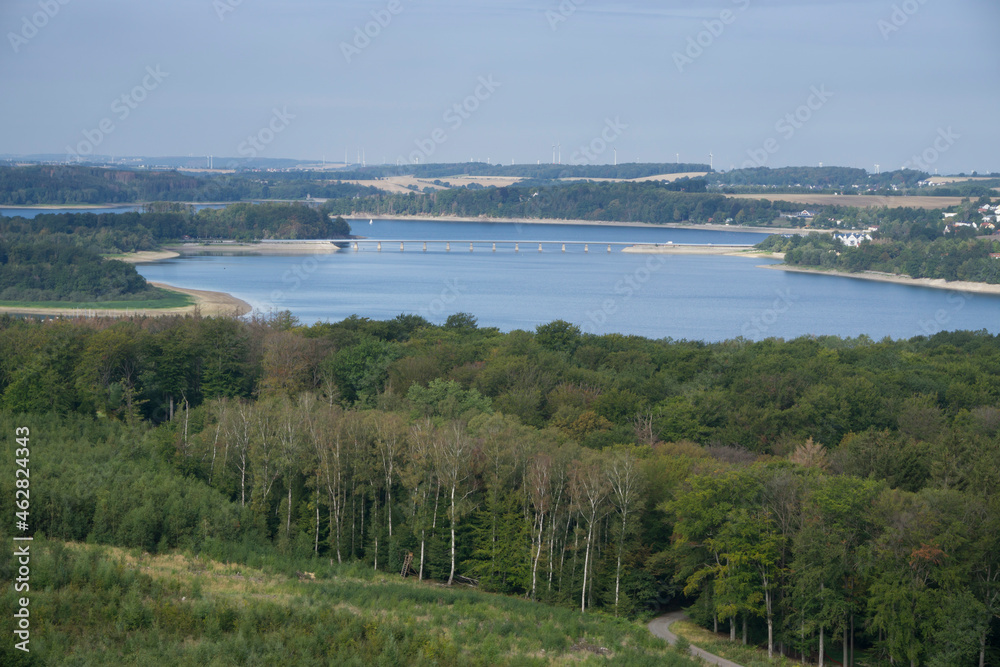 High angle view of sea amidst land against sky during sunny day, Delecke, North Rhine Westphalia, Germany High angle view of sea amidst land against sky during sunny day, Delecke, North Rhine Westphalia, Germany