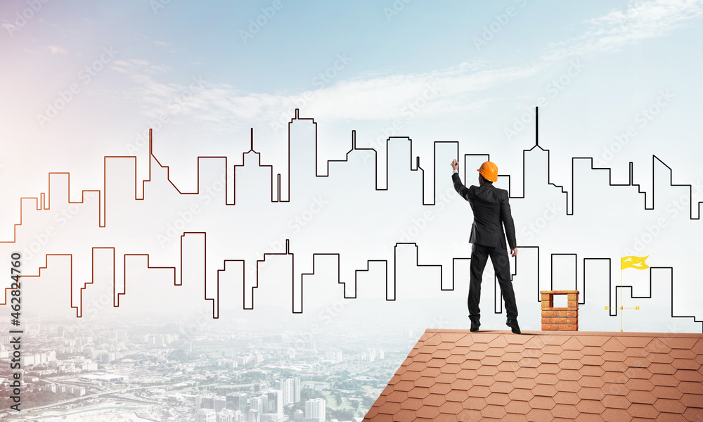 Man architect draw silhouette of modern city on blue sky. Mixed media Man architect draw silhouette of modern city on blue sky. Mixed media