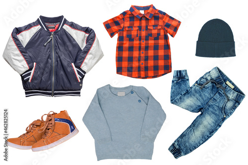 Collage set of little boy autumn clothing isolated on a white background. Denim trouser, a pair shoes, a rain jacket, pullover, a hood,  a shirt  and a sweater for child boy. Kids autum and winter fas © Olga