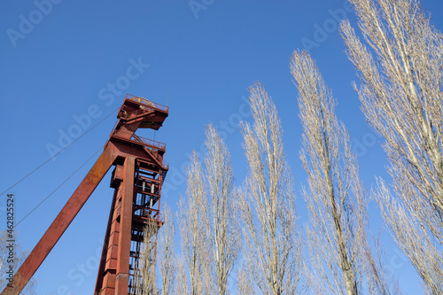 Germany, North Rhine-Westphalia, Kamen, Low angle view of abandoned shaft tower standing against clear sky photo