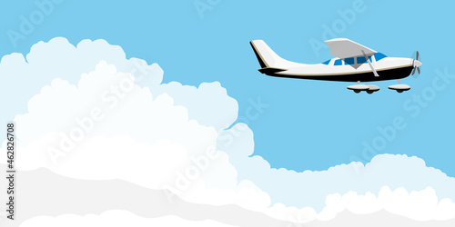 Small single engine airplane cessna flying in blue sky with clouds photo