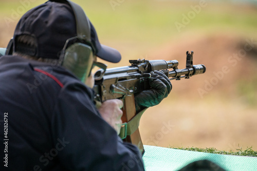 Shooting on target in shooting range. Back close-up detail view