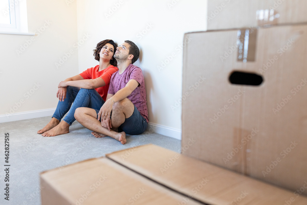 Couple sitting on the floor in new home Couple sitting on the floor in new home