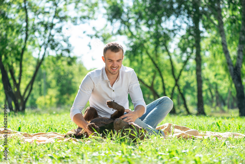 Young man with a dog in the park Young man with a dog in the park