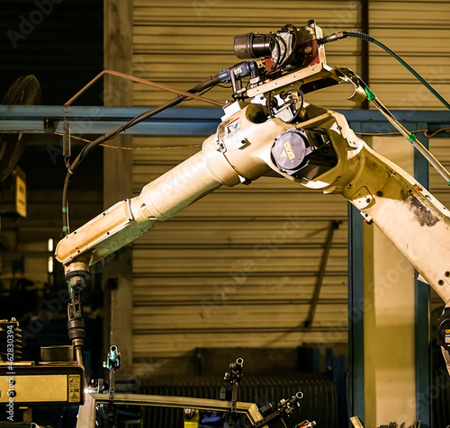 Automated welding robot arm in large factory