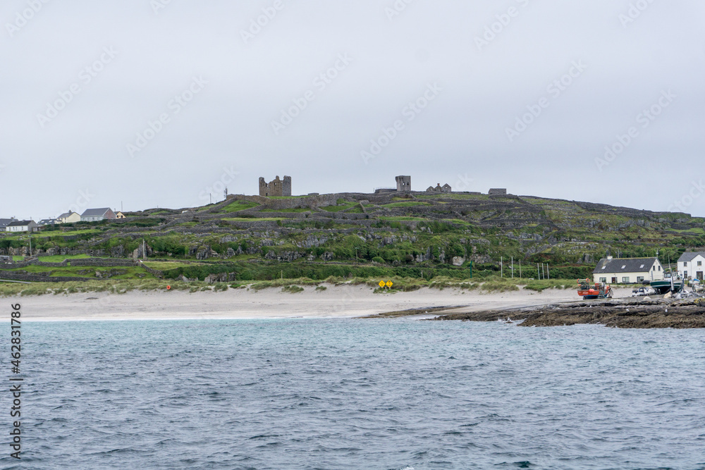 view over Aran Islands with atlantic ocean and old castle on the hill