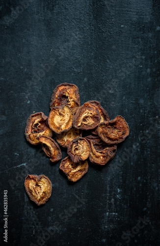 Dried apricots on rustic dark background