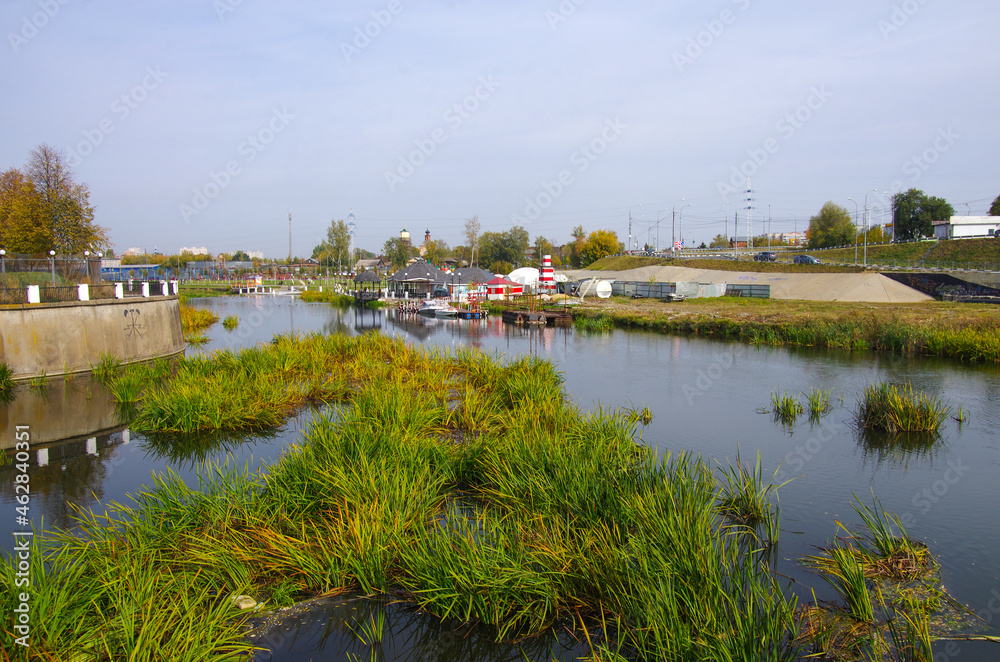 Fototapeta premium Tula, Russia - October 2020: Kazanskaya embankment near the Tula Kremlin with a view of the canal in an autumn day