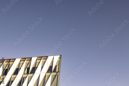 Contemporary building architecture background with sky and copyspace. Geometric shapes and modern background with business buildings