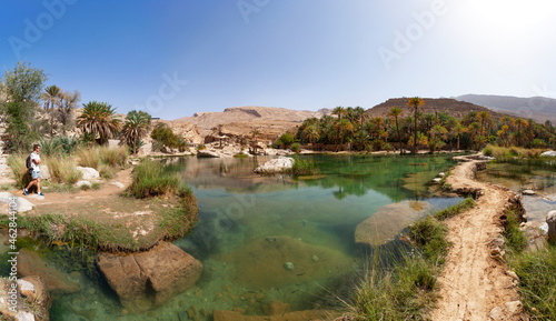Tourist looking at Wadi Bani Khalid, Oman photo