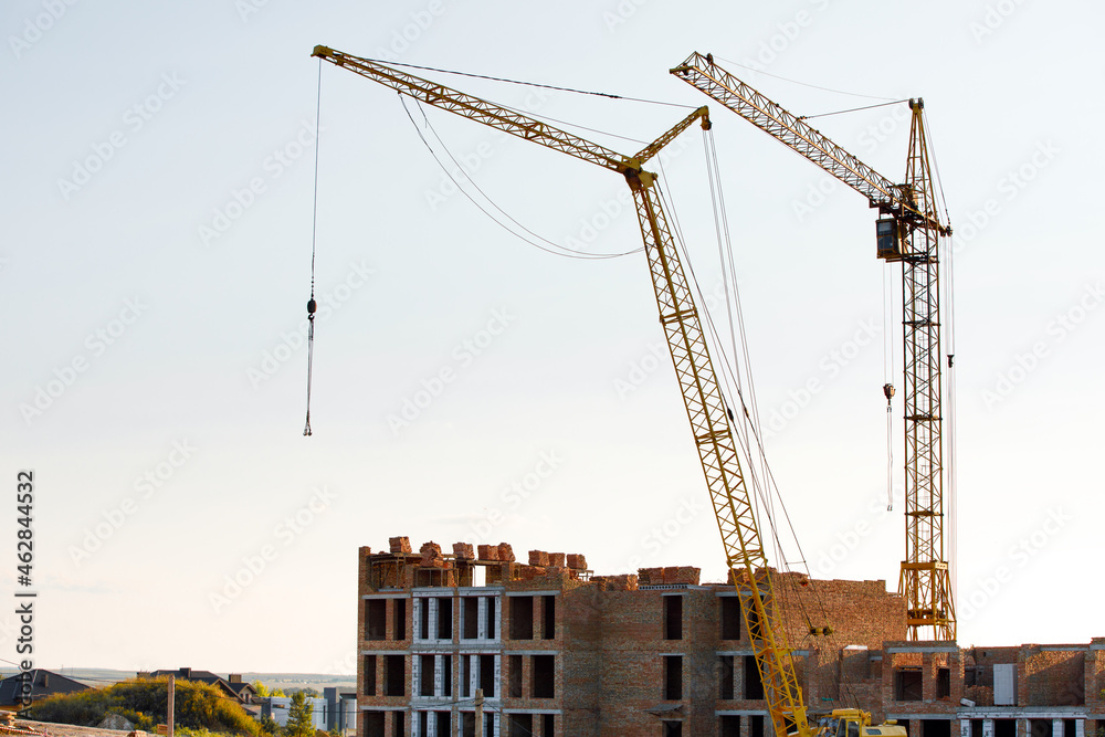 construction site with cranes against the background of new buildings