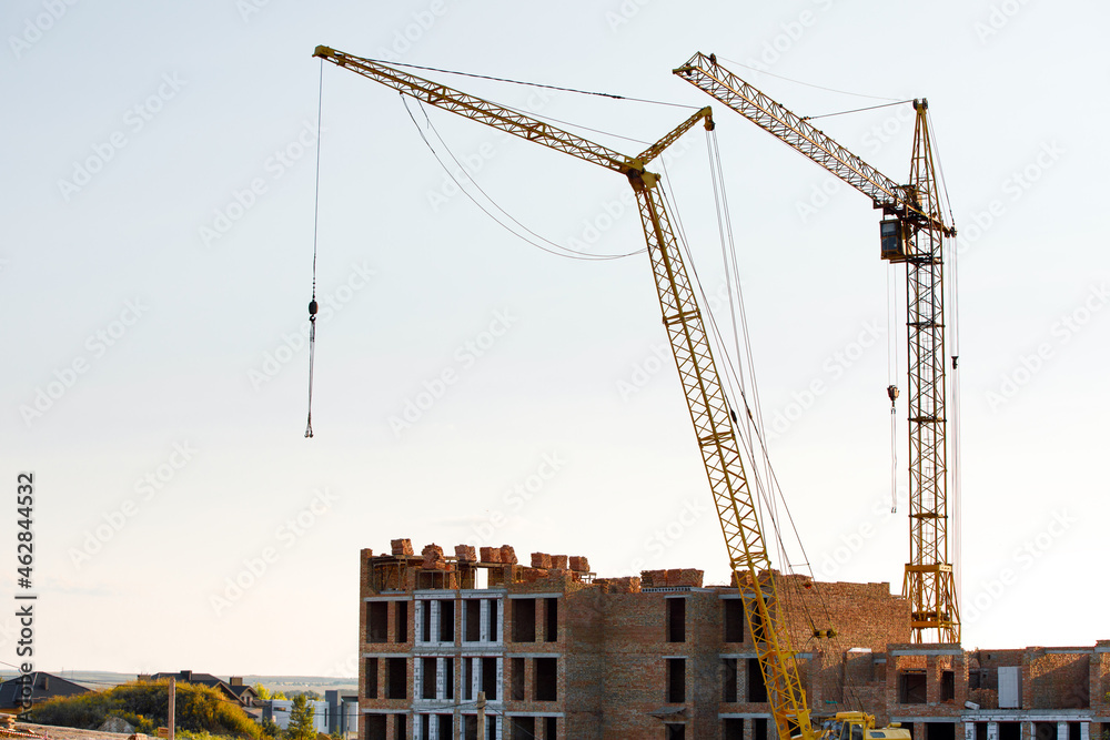 construction site with cranes against the background of new buildings construction site with cranes against the background of new buildings