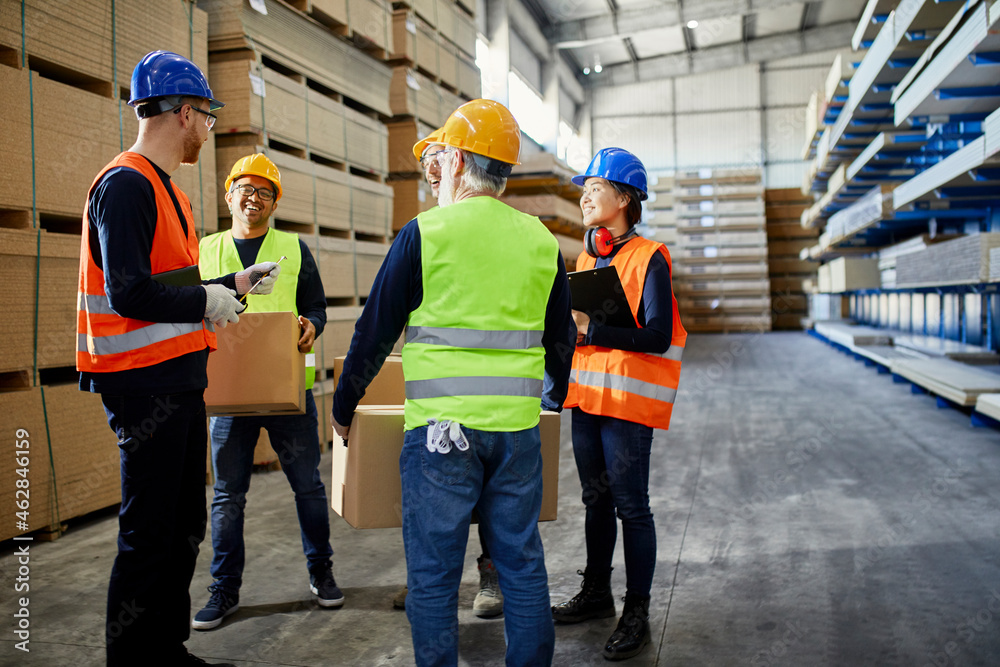 Workers talking in factory warehouse Workers talking in factory warehouse