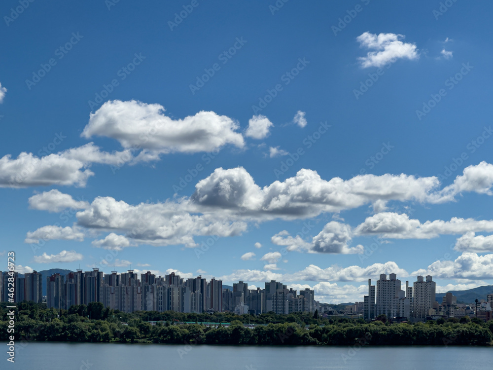 city skyline with beautiful white clouds in the blue sky 