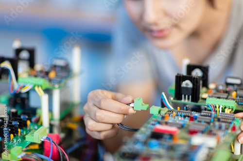 Detail of woman working on motherboard photo