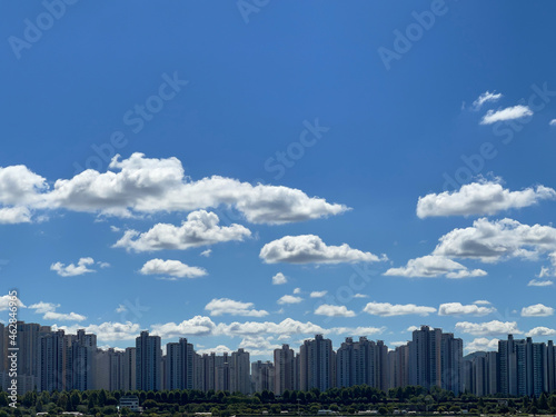 city skyline with beautiful white clouds in the blue sky