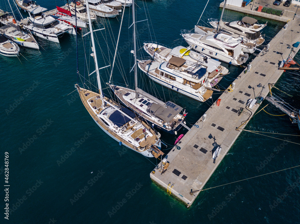 Aerial panoramic view of marina port with yachts and sailboats in Mediterranean sea