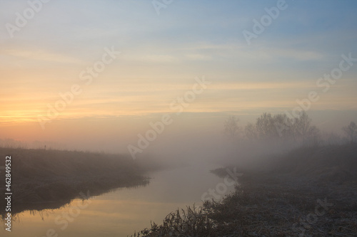 Fototapeta Naklejka Na Ścianę i Meble -  morning fog over the river red dawn