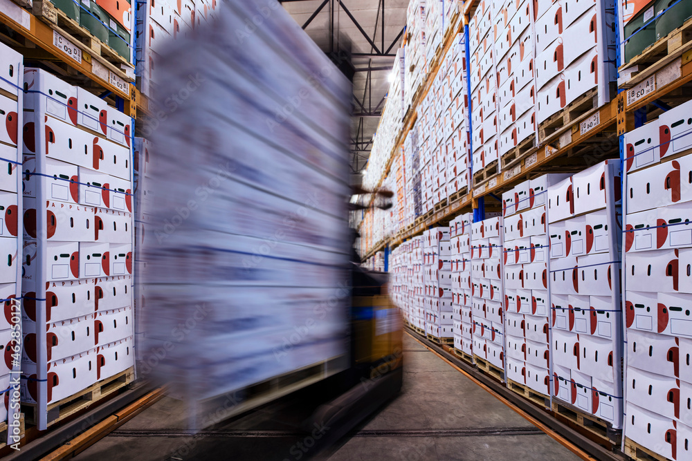 Moving forklift in factory hall loading boxes Stock Photo | Adobe Stock
