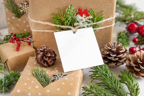 Christmas present with square blank gift tag close up, Mockup