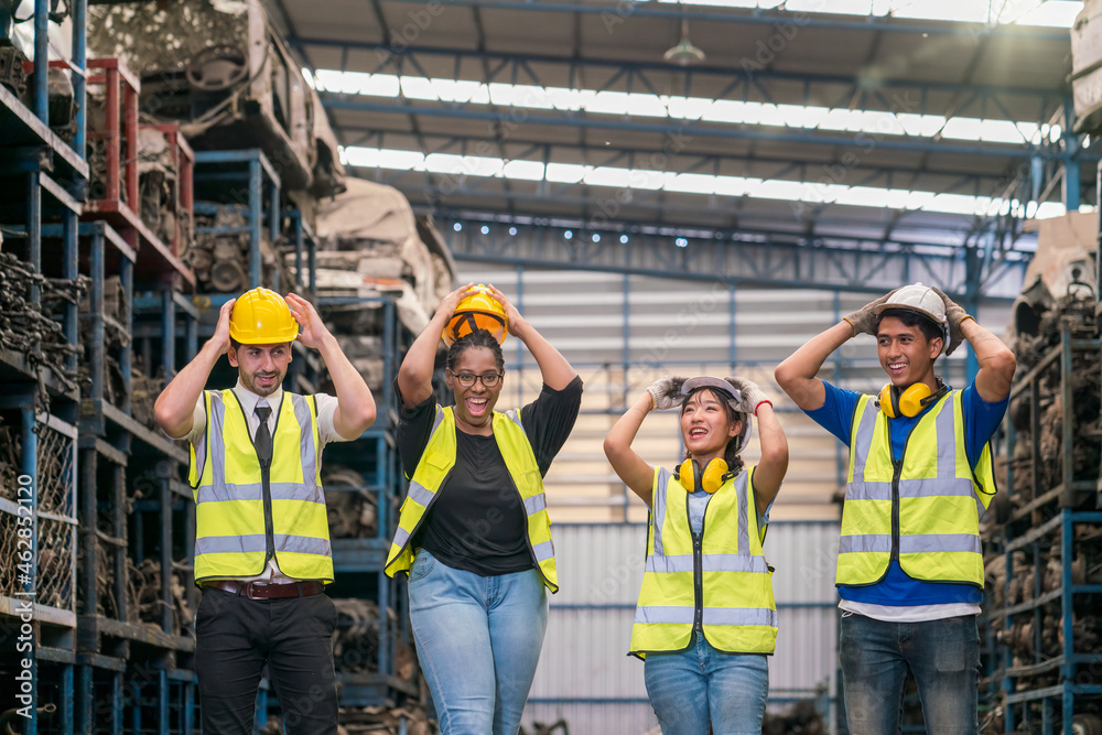 Group of employees and engineers in industrial plants. Team of workers and engineer Excited engineer celebrating in parts warehouse. Group of employees and engineers in industrial plants. Team of workers and engineer Excited engineer celebrating in parts warehouse.
