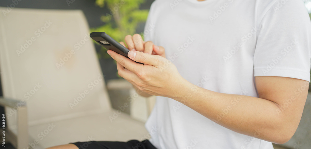 slow motion scene young middle eastern man hold smartphone to use by surfing the internet or read news on website or social media network at outside cafe for technology and. lifestyle concept	