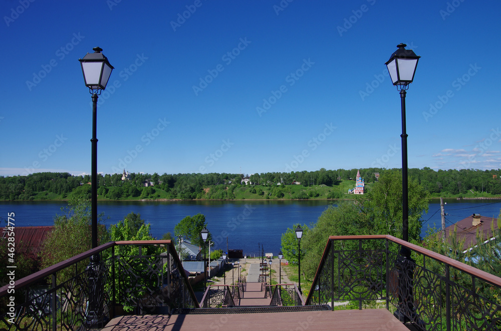 Tutaev, Russia - May, 2021: Volga river embankment on a spring day and a view of the Romanovskaya side of Tutaev