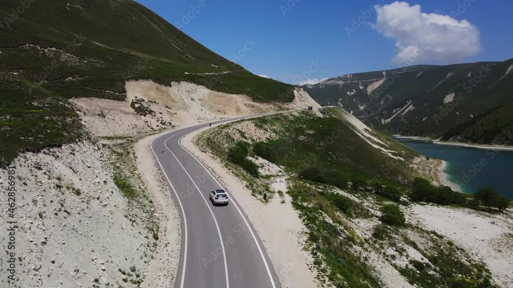 Car Moving along Kazenoy Am Lake in Chechen Republic, Russia. Aerial View Car Moving along Kazenoy Am Lake in Chechen Republic, Russia. Aerial View
