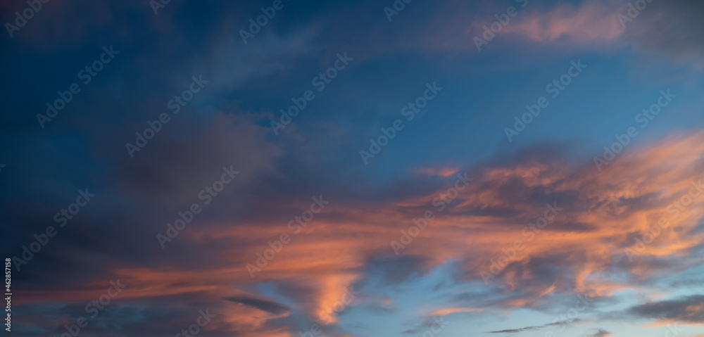 Sunset sky with orange clouds. Nature background.