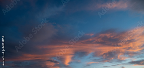 Sunset sky with orange clouds. Nature background. © Vladimir Arndt