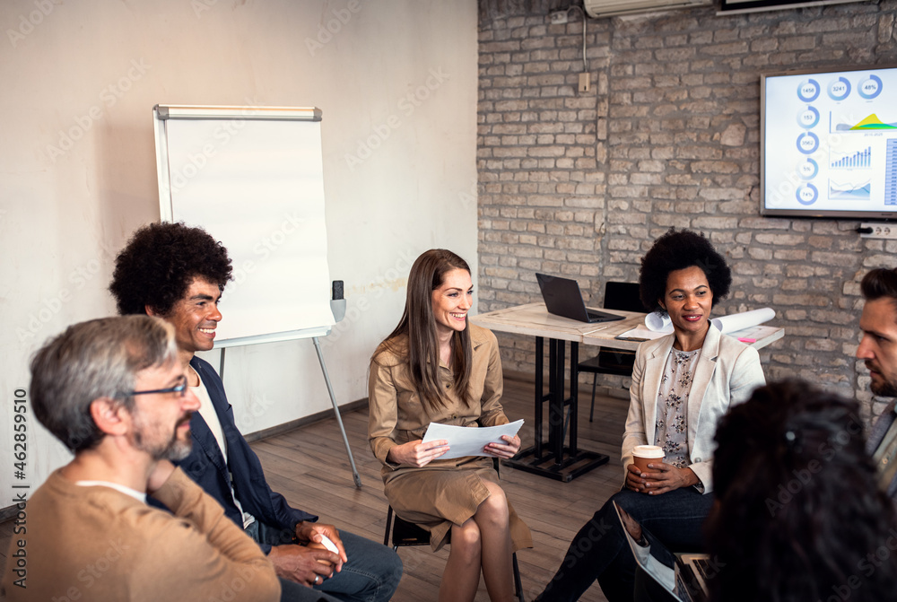 Fototapeta premium Group of diverse group of business people having a meeting while sitting in circle.
