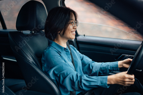 Happy businesswoman driving a car. © bnenin