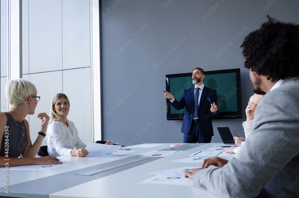 Fototapeta premium Group of business people discussing project in the office. Meeting, teamwork concept.