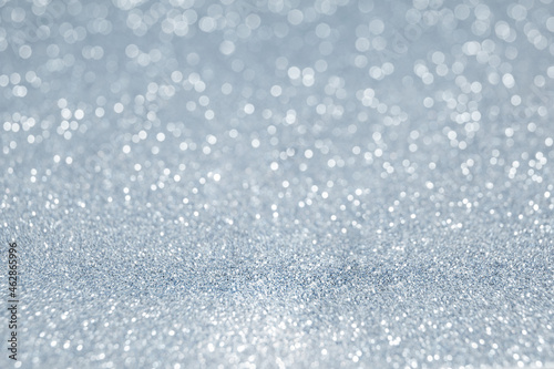 Blue-gray winter background with shimmering sparkles. Blurred background. Suitable for making banners, cards and any New Year and Christmas design