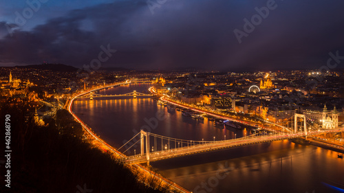 Panorama of night-time Budapest with illuminated bridges over the Danube River. 